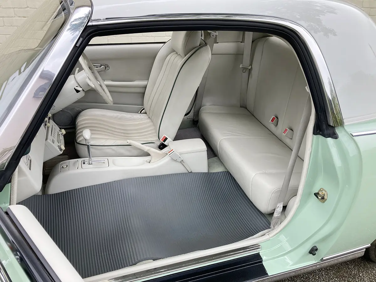 Nissan Figaro retro classic car interior with the passenger seat removed