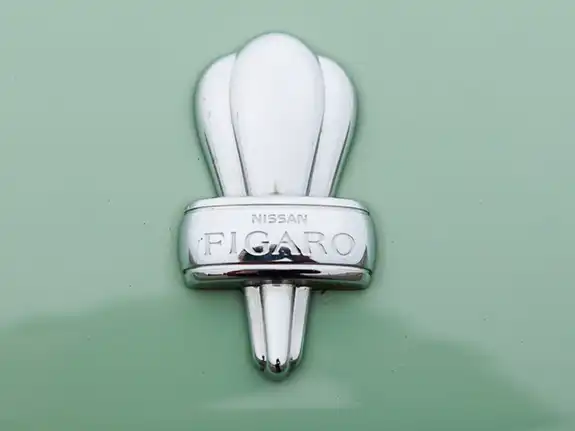 Vintage bridal car rental Nissan Figaro classic car badge