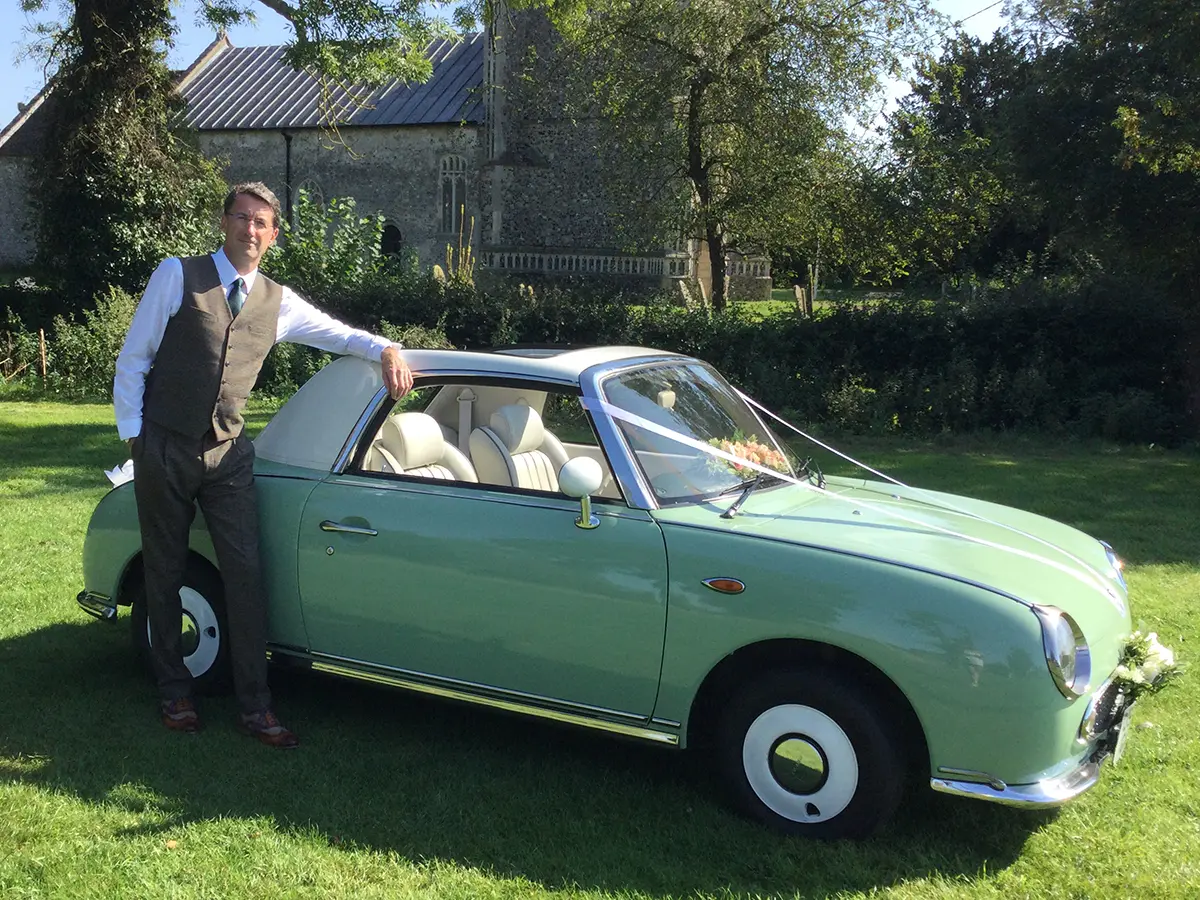 Chauffeur-driven vintage wedding car rental Nissan Figaro classic car with chauffeur