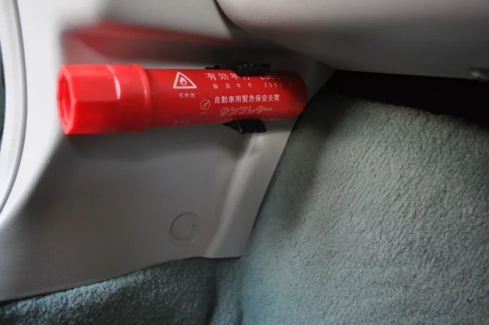 Emergency breakdown flare clipped inside a Nissan Figaro