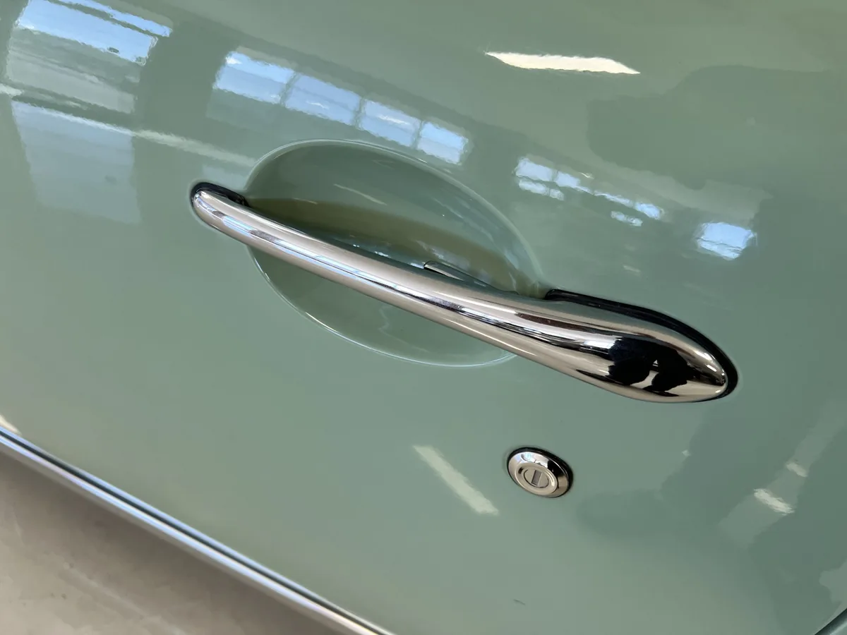 Chrome exterior door handle on a Nissan Figaro