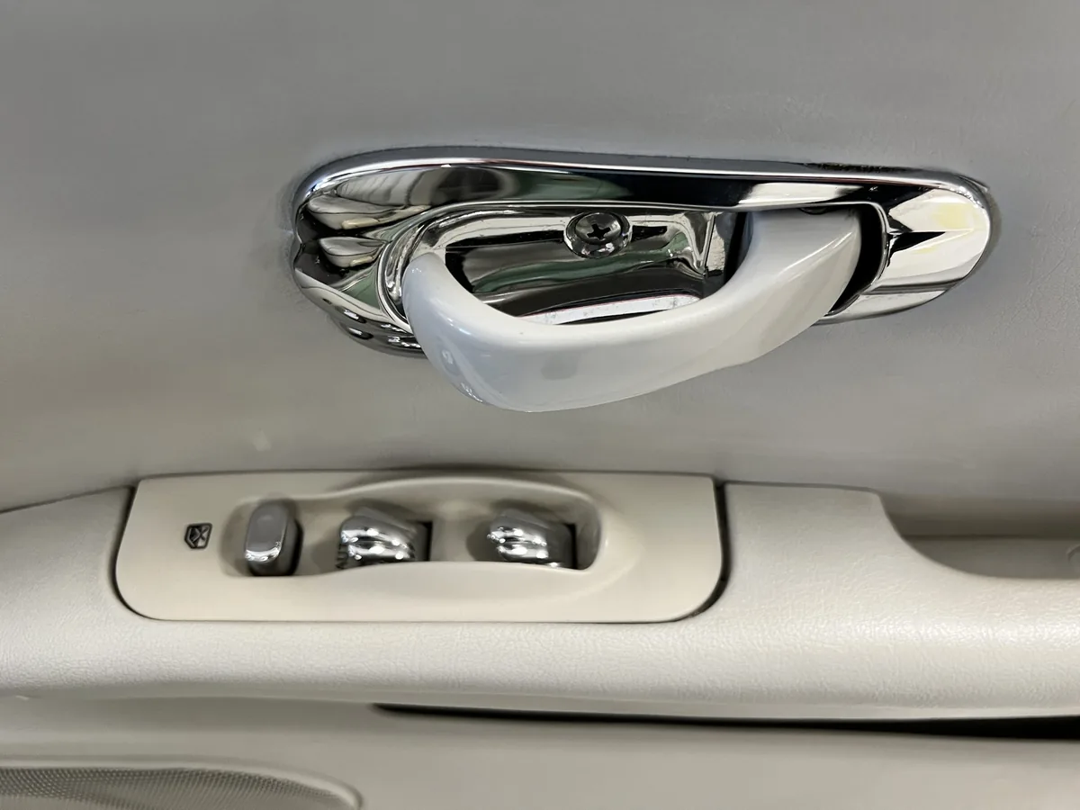 Interior door handle and window switches in a Nissan Figaro