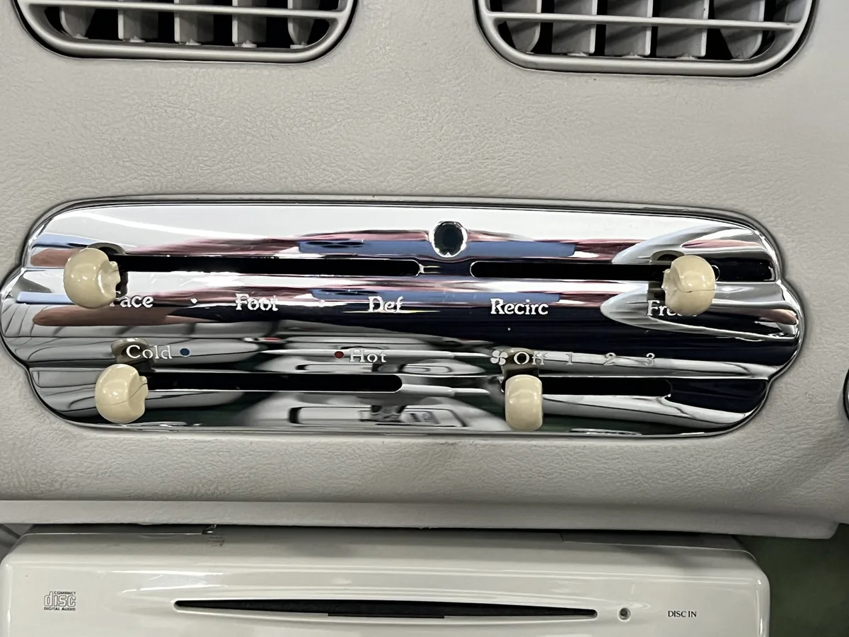 Chrome heater control panel in a Nissan Figaro