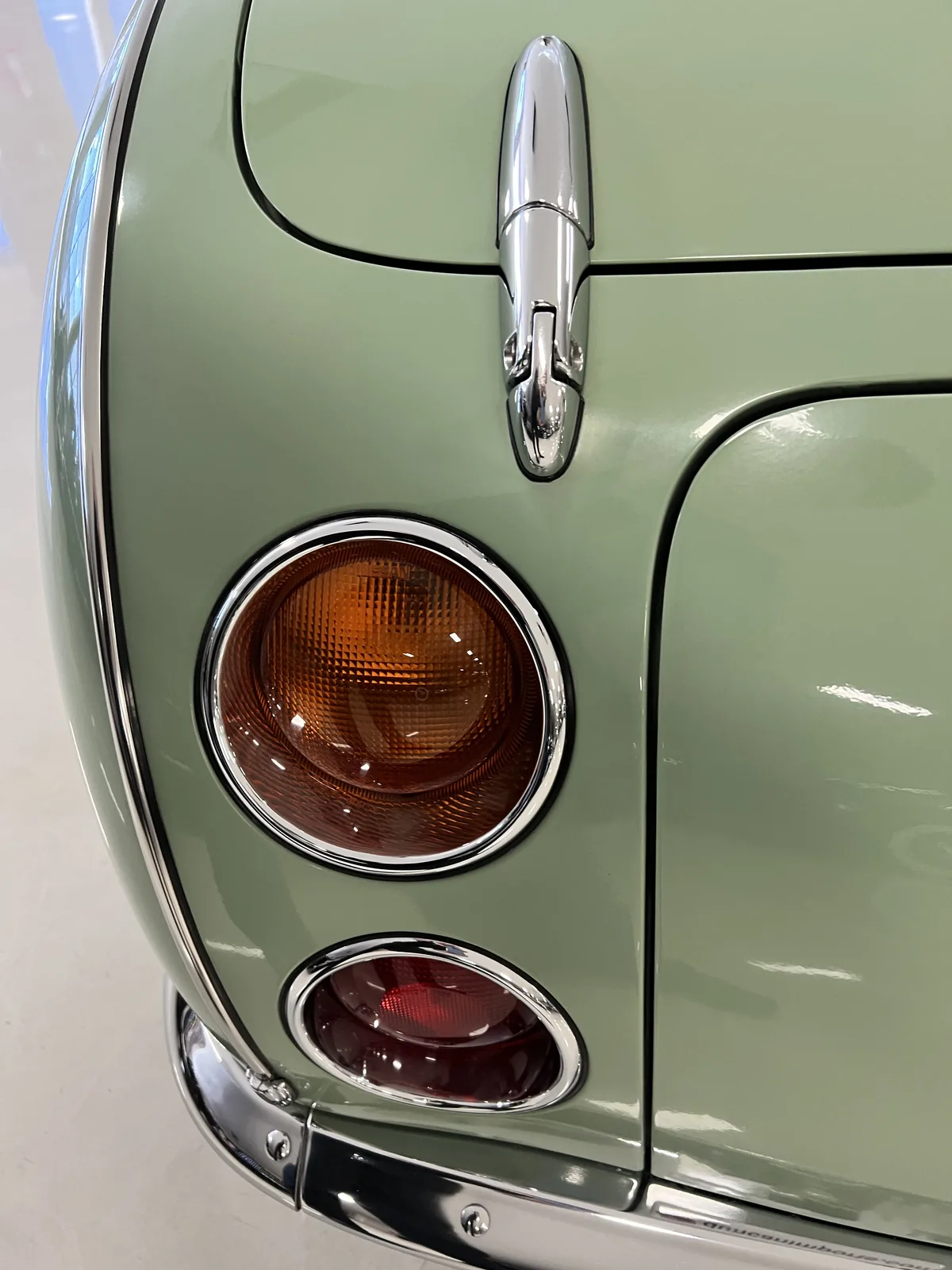 Round rear lights with chrome surrounds on a Nissan Figaro