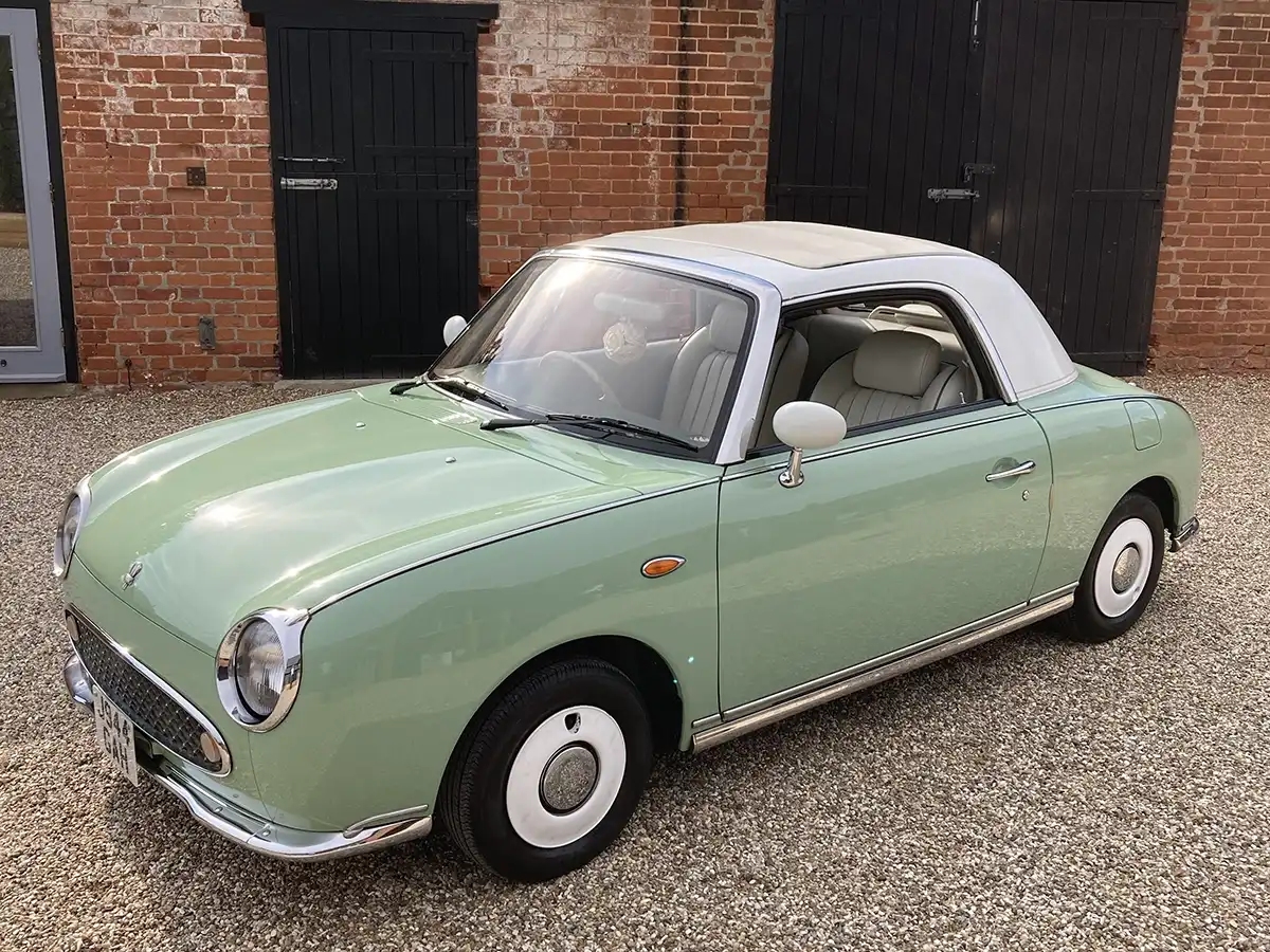 The Nissan Figaro, a retro Japanese cabriolet from 1991 Nissan Figaro two-door cabriolet, front three-quarter view with the roof up