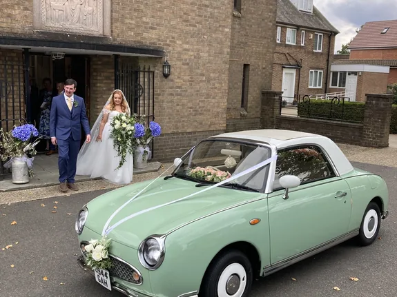 Nissan Figaro wedding car outside Our Lady of Walsingham church in Corby, Northamptonshire